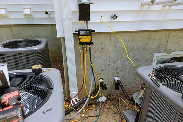 Outdoor HVAC units connected to HVAC tool to detect problems with the unit.